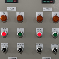 A gray machine control panel with multiple indicator lights and switches.